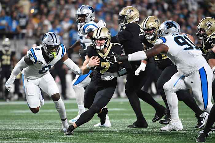 Sep 18, 2023; New Orleans Saints quarterback Taysom Hill (7) runs against Carolina Panthers linebacker Brian Burns (0) and defensive end Nick Thurman (91). Mandatory Credit: Bob Donnan-USA TODAY Sports